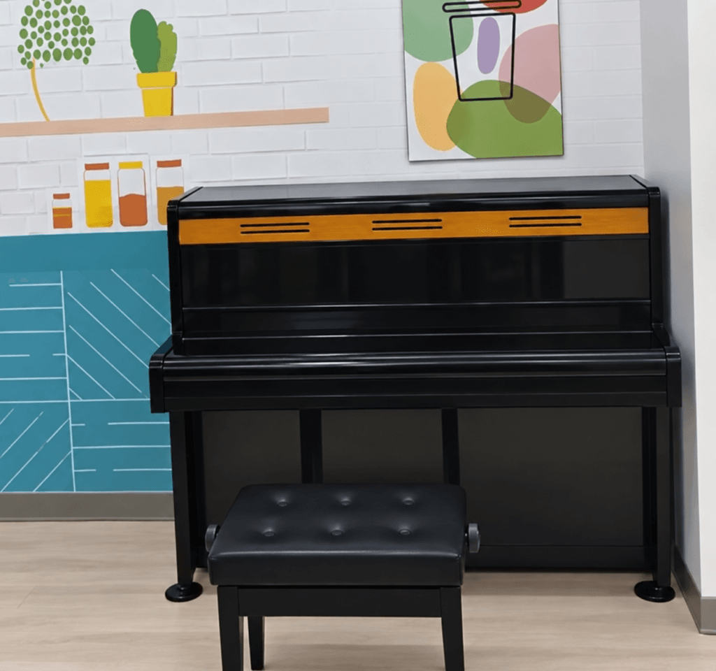 Black upright public piano at 7-ELEVEN Yongyu Store near Jiaoxi Station